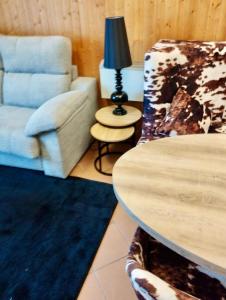 a living room with a couch and a chair at Apartamento a pie de pista en edificio Enebro con parking in Sierra Nevada