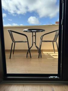 a table and two chairs sitting on a balcony at Cozy and Stylish Apartament in Stara Zagora