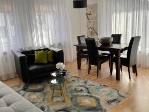 - un salon avec un canapé, une table et des chaises dans l'établissement Cosy Home auf Zeit, à Nuremberg
