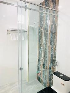 a shower with a glass door in a bathroom at T&T Luxury Hotel in Quy Nhon