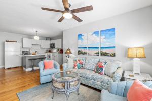 a living room with a couch and a table at Flagler Suites 3 in New Smyrna Beach