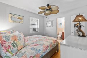 a bedroom with a bed and a ceiling fan at Flagler Suites 3 in New Smyrna Beach