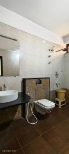 a bathroom with a sink and a toilet at The Lotus Boutique Hotel in Chikmagalūr