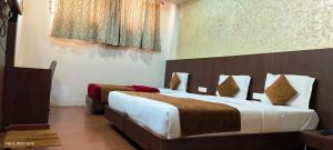 a bedroom with two beds and a painting on the wall at The Lotus Boutique Hotel in Chikmagalūr