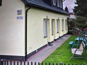 a building with a playground next to a swing at Nadmorska Ostoya in Władysławowo