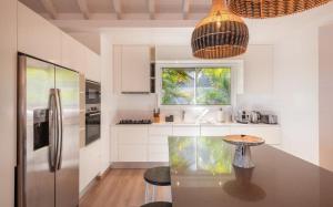 a kitchen with a counter with a table in it at Luxury Vacation Villa 21 in Petit Cul de Sac