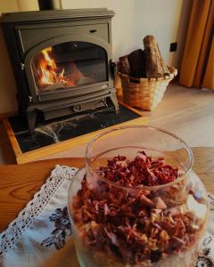 a glass bowl of food on a table with a fireplace at La Galiana loft nature in Casarejos