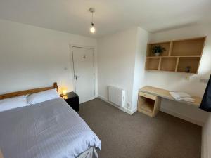 a bedroom with a bed and a desk in it at Student Village 5 minutes from limerick city centre in Limerick