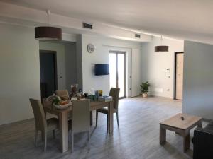 a dining room and living room with a table and chairs at Appartamento vista mare a Trebisacce in Trebisacce