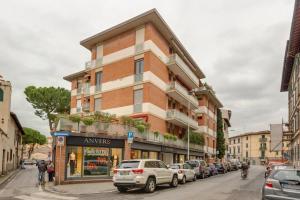 un edificio in una strada di città con auto parcheggiate di Residenza Savoia a Firenze