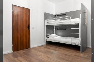 a room with two bunk beds and a wooden door at Nest Boutique Hostel in Bucharest