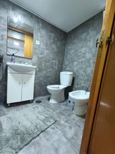 a bathroom with a toilet and a bidet and a sink at Horta da Vilariça House in Torre de Moncorvo