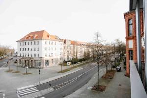 eine leere Stadtstraße mit einem weißen Gebäude und Gebäuden in der Unterkunft Gropius in Dessau