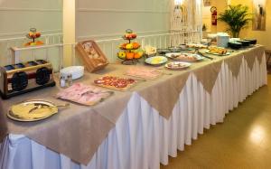 a long table with food on top of it at Hotel Villa Benvenuti in Viareggio