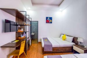 Postel nebo postele na pokoji v ubytování Richy Dalat Hotel