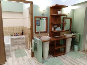 a bathroom with two sinks and a mirror at L'hacienda in Tartas +40 photos