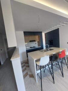 a kitchen with a table and chairs in a room at The Wave residence Chott Meriam Sousse in El Ahmar