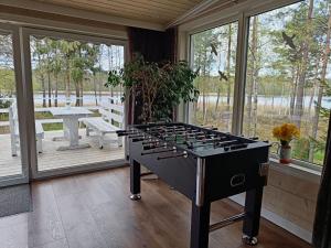 a ping pong table on a screened in porch at Sosnowy Azyl in Wąglikowice