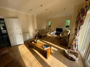 a living room with a couch and a table at Great stay in a beautiful and cosy house in Bournemouth