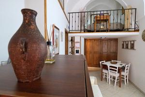 a vase sitting on top of a table in a room at Vicolo dell'Arco in Fasano
