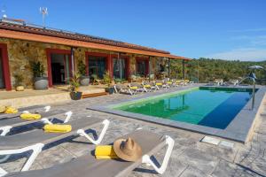 a resort with a swimming pool and lounge chairs at Villa Silence Lux with Pool in Nature and Aircon in Maçanet de la Selva