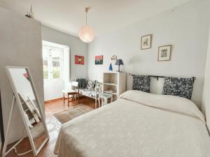 a bedroom with a bed and a mirror in it at Casa da Figueira in Sanxenxo