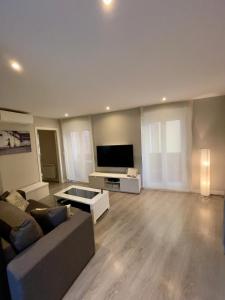 a living room with a couch and a flat screen tv at La Casa del Abuelo in Tudela