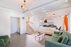 a living room with a couch and a table at Villa Simge 3+1 Ölüdeniz in Fethiye