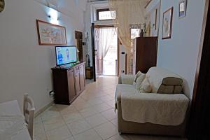 a living room with a couch and a television at Vicolo dell'Arco in Fasano