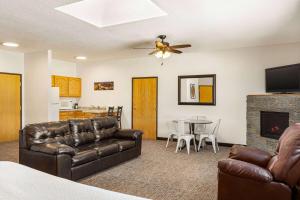 a living room with a couch and a table at Ramada by Wyndham Richland Center in Richland Center