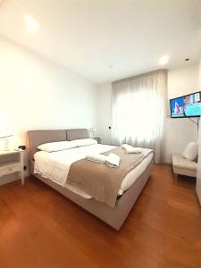 a bedroom with a large bed and a flat screen tv at YourHome in Vico in Vico Equense