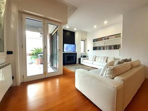 a living room with a white couch and a television at YourHome in Vico in Vico Equense