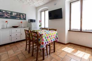 a kitchen with a table and chairs in a room at Ledro Lake Suite "Pur" in Mezzolago
