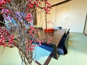 a table with a tree with red berries on it at 2名様におすすめ 山手駒込駅徒歩3分 Switch付き池袋新宿秋葉原上野浅草渋谷 in Tokyo +33 photos
