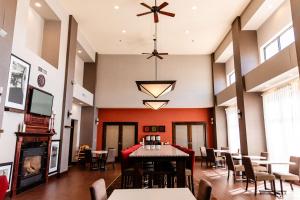 a dining room with a table and chairs and a chandelier at Hampton Inn & Suites Scottsbluff in Scottsbluff