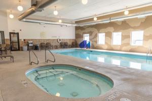 a large swimming pool in a building with a swimming pool at Hampton Inn & Suites Scottsbluff in Scottsbluff