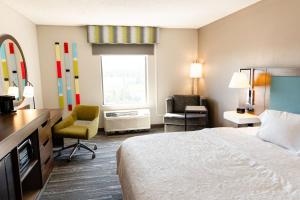 a hotel room with a bed and a desk and chair at Hampton Inn & Suites Scottsbluff in Scottsbluff