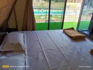 a bed in a tent with a bag on it at Lord Sunrise- Shanker Farm Villa in Kīhīm