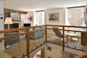 a living room with a staircase with a chair at House on the Harbour Pittenweem in Pittenweem