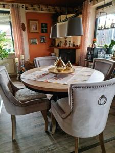 a dining room with a wooden table and chairs at Pension Bütterich in Husum