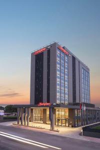 a large building with a sign on the side of it at Hampton by Hilton Antalya Airport in Antalya