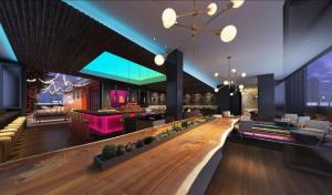 a lobby with a bar and a restaurant at Canopy By Hilton Nashville Downtown The Gulch in Nashville
