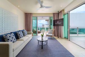 a living room with a couch and a table at Wyndham Grand Barbados Sam Lords Castle All Inclusive Resort in Saint Philip