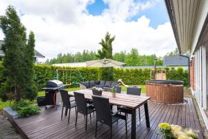 a patio with a table and chairs and a grill at Vantaa Sauna Cottage in Vantaa