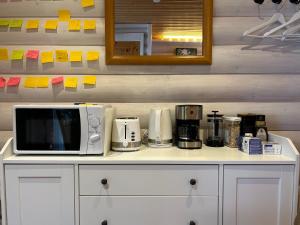 a microwave sitting on top of a counter at Peaceful Wood-fired Sauna Stay in Vantaa