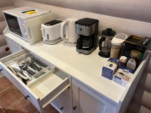 a white counter top with appliances on it at Vantaa Sauna Cottage in Vantaa