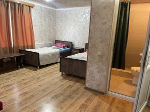 a room with two beds and a mirror at Guest House Villa in Kvareli