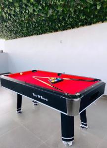 a red pool table sitting in front of a wall at 1 Bedroom Flat Sangotedo Ajah in Sangotedo
