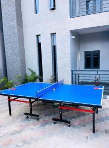 a blue ping pong table in front of a building at 1 Bedroom Flat Sangotedo Ajah in Sangotedo