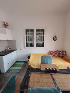 a living room with a bed and a kitchen at Ανατολή in Veria